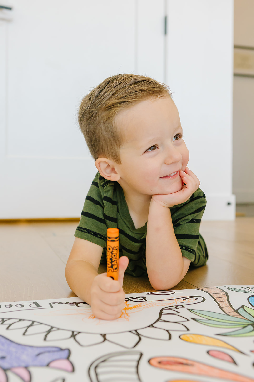Boy smiling while coloring