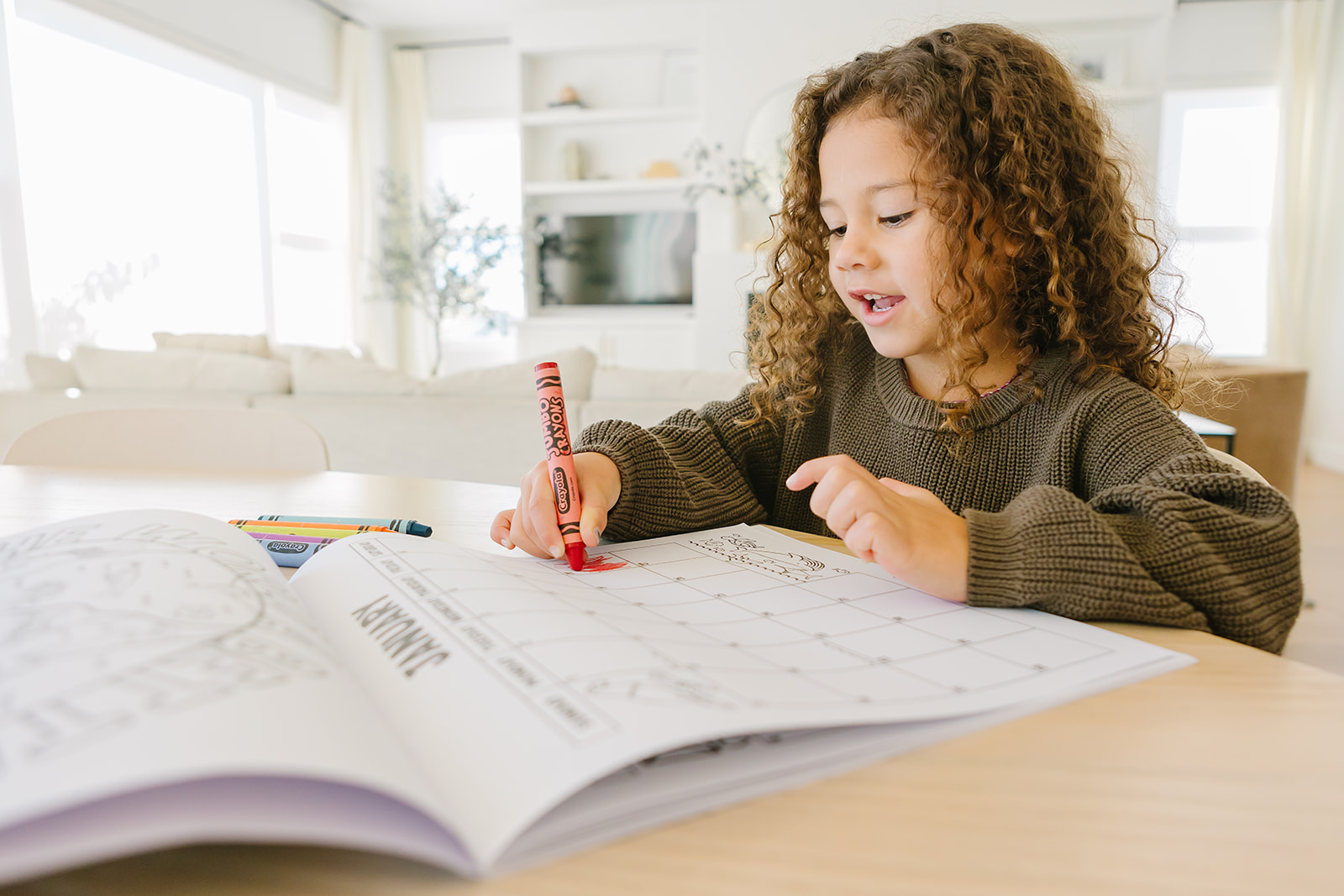 Girl coloring a calendar